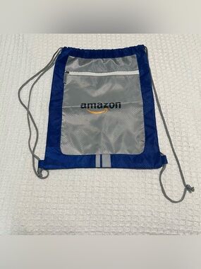 NWOT Amazon Logo Drawstring Backpack 16”x13” Royal Blue/Silver Zippered Pocket